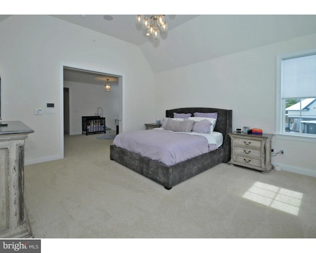 bedroom with light colored carpet, lofted ceiling, and an inviting chandelier