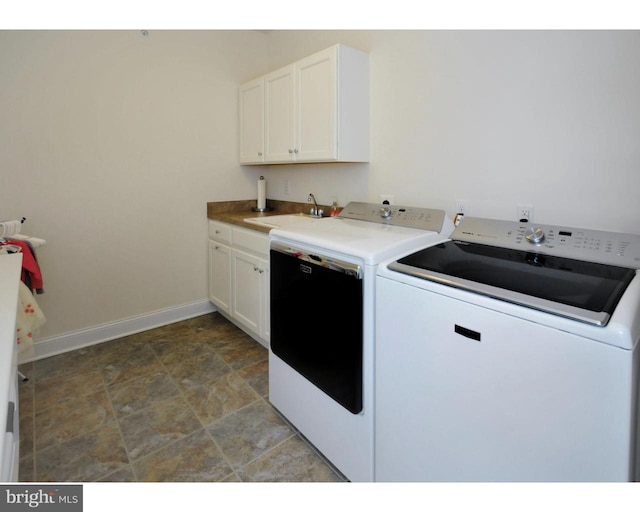 laundry room with cabinets, separate washer and dryer, and sink