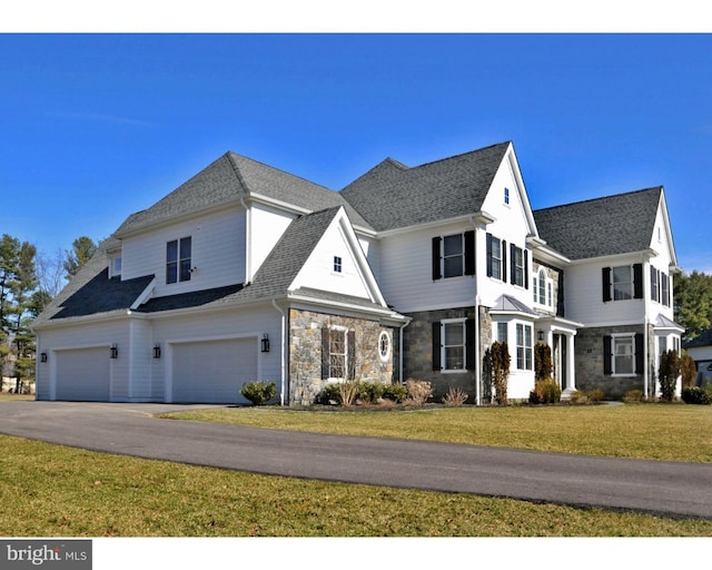 view of front of property featuring a garage and a front lawn