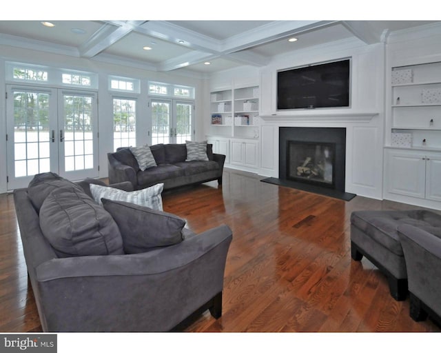 living room with beam ceiling, built in features, and french doors