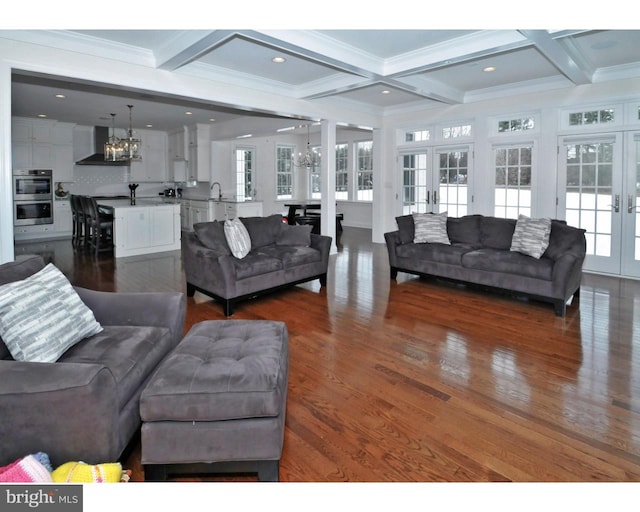 living room with french doors, coffered ceiling, a notable chandelier, beamed ceiling, and dark hardwood / wood-style floors