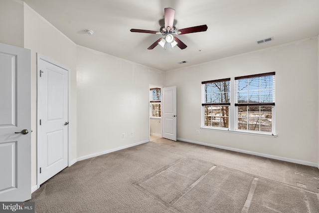 unfurnished bedroom with light colored carpet and ceiling fan