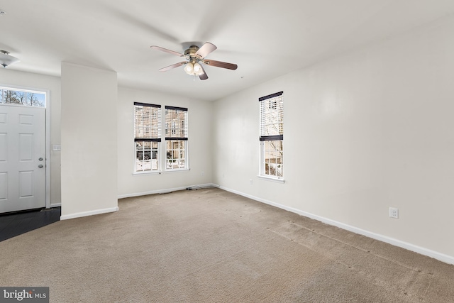 carpeted foyer entrance featuring ceiling fan