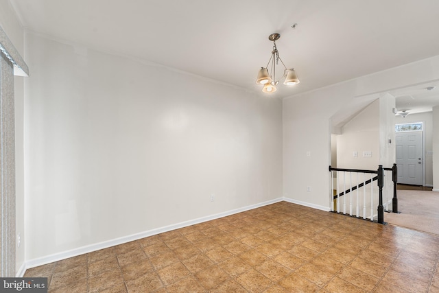 unfurnished room featuring a notable chandelier