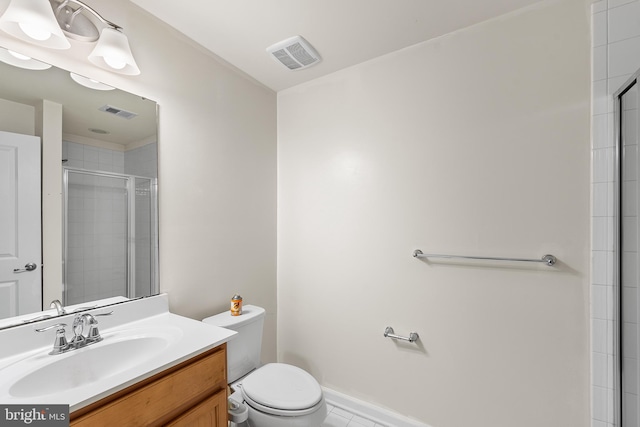 bathroom featuring tile patterned flooring, walk in shower, vanity, and toilet