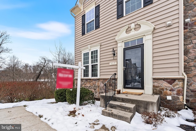 view of snow covered property entrance