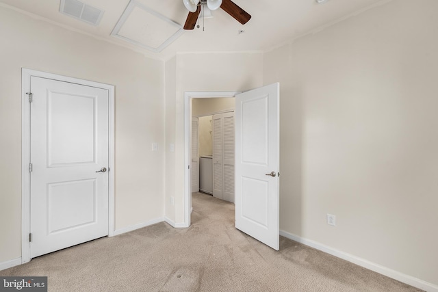 unfurnished bedroom with ceiling fan and light colored carpet