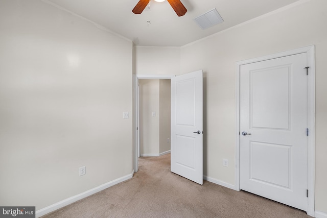 unfurnished bedroom with light colored carpet and ceiling fan