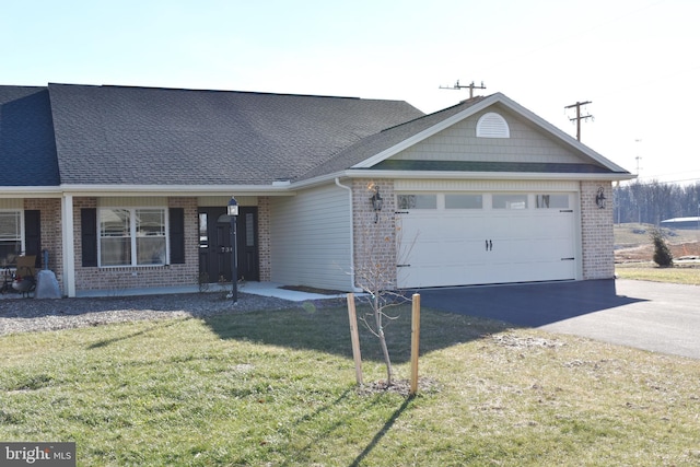 view of front of property with a garage and a front yard