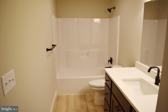 full bathroom with hardwood / wood-style floors, vanity, toilet, and shower / bathtub combination