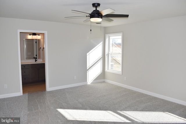 carpeted empty room with ceiling fan and sink