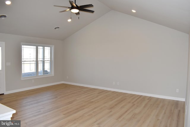 unfurnished room with ceiling fan, lofted ceiling, and light hardwood / wood-style flooring