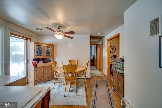 dining space featuring light wood-type flooring and ceiling fan