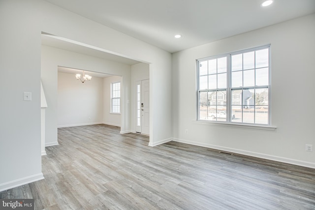 interior space with light hardwood / wood-style floors and a chandelier