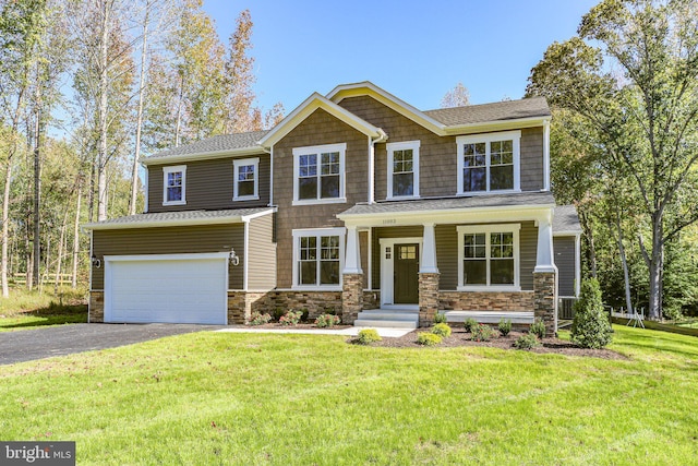 view of front of property with a garage and a front lawn