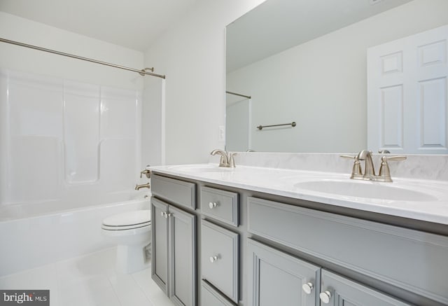 full bathroom with tile patterned floors, toilet, vanity, and washtub / shower combination