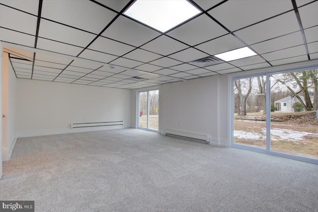 empty room with carpet flooring and a baseboard heating unit