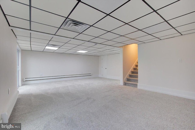 basement with baseboard heating and carpet