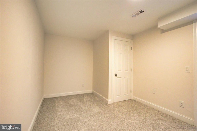 spare room featuring light colored carpet