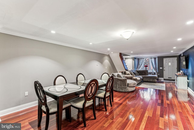 dining space with hardwood / wood-style flooring and crown molding