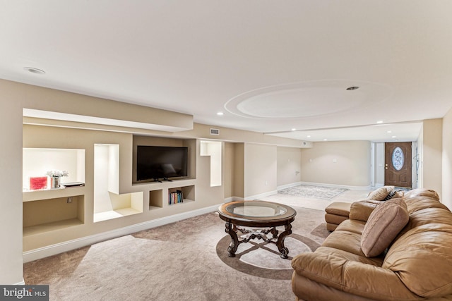 carpeted living room featuring built in shelves