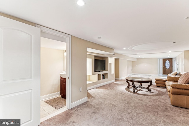 living room with built in shelves and light carpet