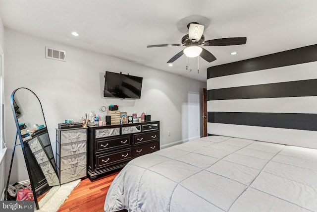 bedroom with ceiling fan and light hardwood / wood-style flooring