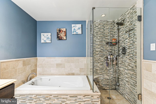 bathroom with vanity and independent shower and bath