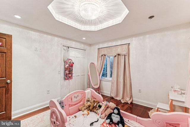 bedroom with a chandelier and hardwood / wood-style flooring