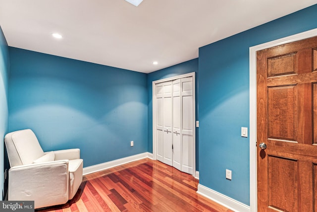 living area with hardwood / wood-style floors