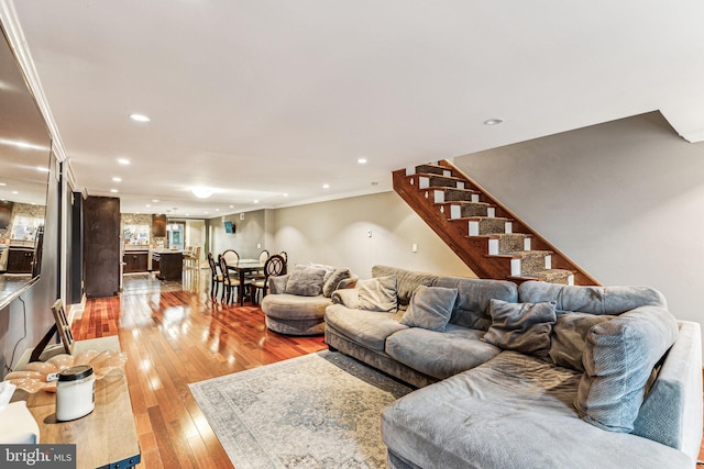 living room featuring hardwood / wood-style flooring and ornamental molding