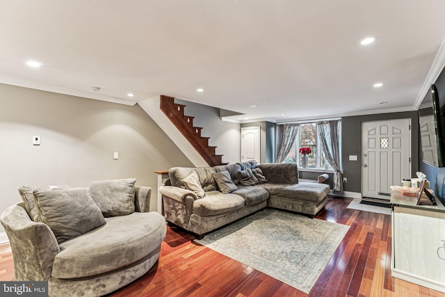 living room with dark hardwood / wood-style flooring and ornamental molding