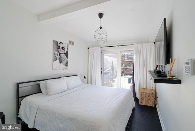 bedroom featuring vaulted ceiling with beams and dark hardwood / wood-style floors