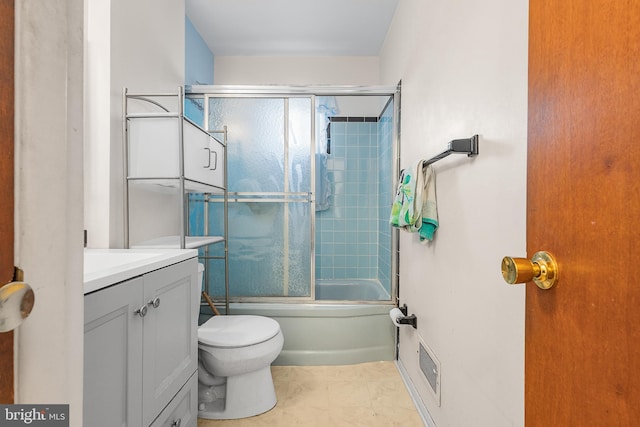 full bathroom featuring vanity, toilet, and combined bath / shower with glass door