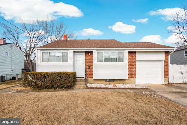 single story home with a garage, cooling unit, and a front lawn