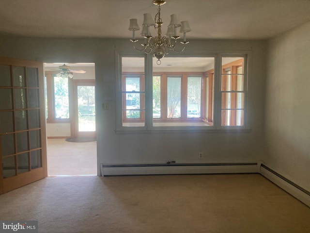 unfurnished dining area with ceiling fan with notable chandelier, carpet floors, french doors, and a baseboard heating unit