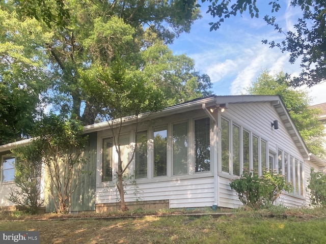 view of side of property with a sunroom