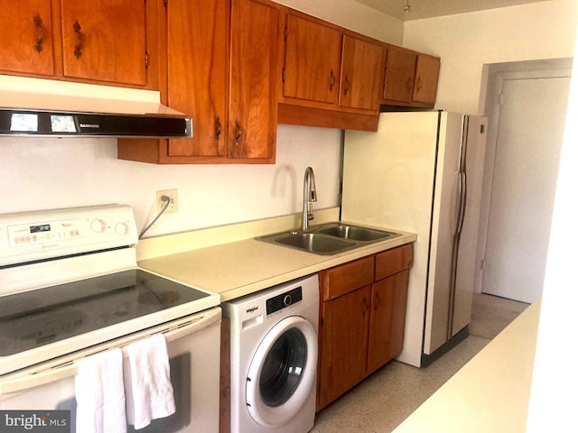 kitchen featuring white appliances, washer / clothes dryer, and sink