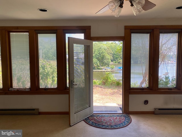 entryway with baseboard heating, ceiling fan, a water view, and light colored carpet