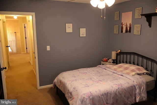 bedroom with ceiling fan and light colored carpet