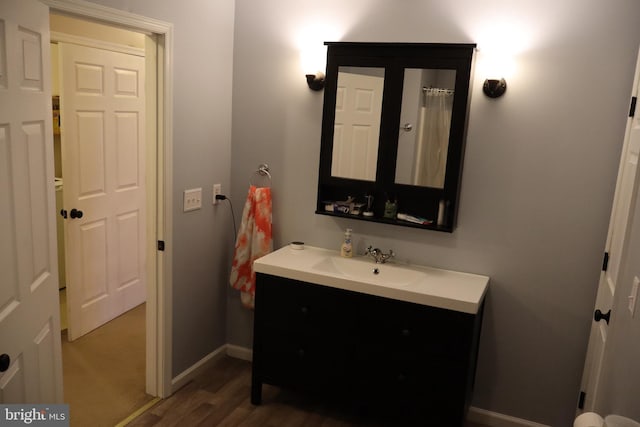 bathroom with vanity and hardwood / wood-style flooring