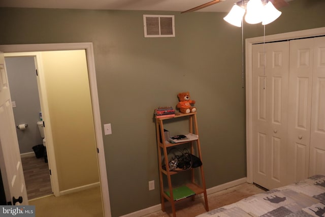 carpeted bedroom with a closet and ceiling fan