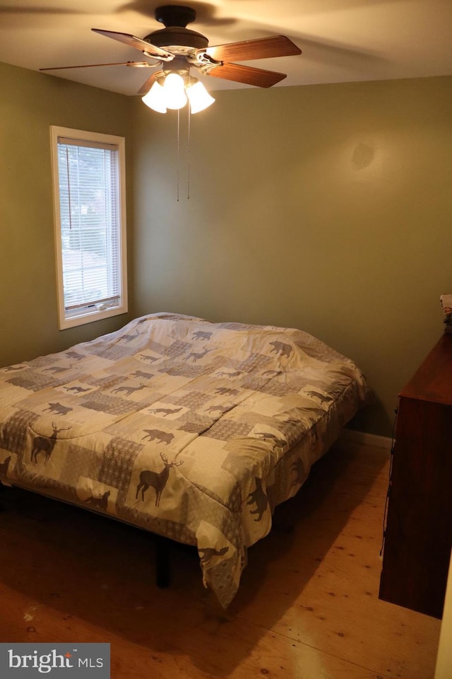 bedroom with ceiling fan and hardwood / wood-style floors