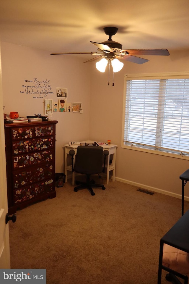 interior space with ceiling fan and carpet