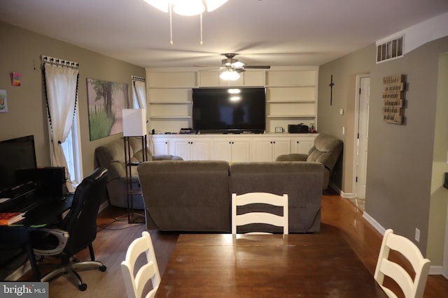 living room featuring ceiling fan and hardwood / wood-style floors