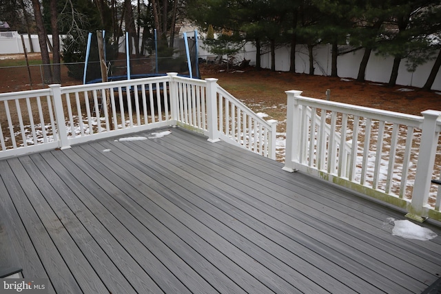 wooden terrace with a trampoline