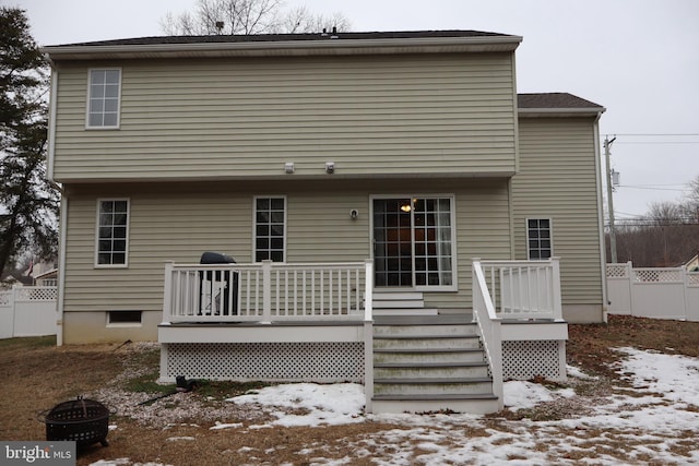 snow covered house featuring a wooden deck