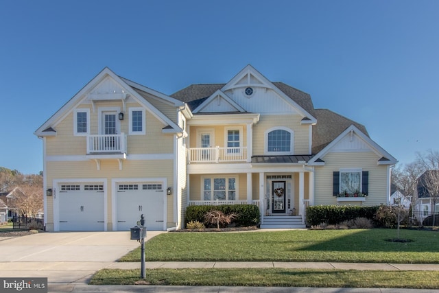 view of front of house with a garage, a balcony, and a front yard