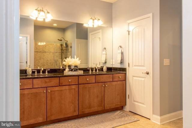 bathroom with tile patterned floors, vanity, walk in shower, and an inviting chandelier