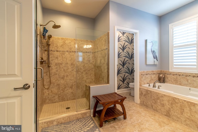 bathroom with tile patterned floors, toilet, and independent shower and bath